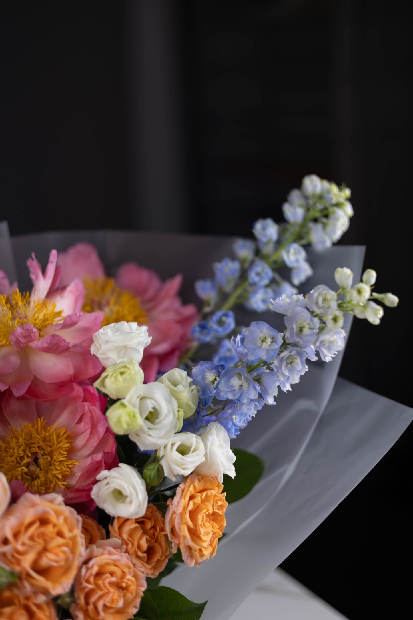 Close-up of bouquet edge showcasing pastel blooms and layered textures