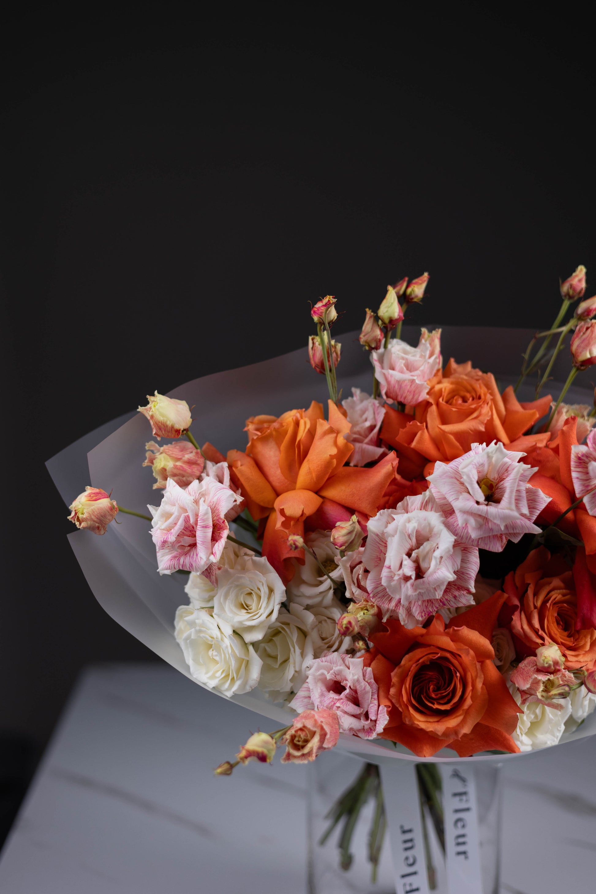 Elegant orange rose bouquet with soft white and blush flowers