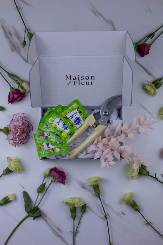 Maison d'Fleur box with floral items on a marble surface