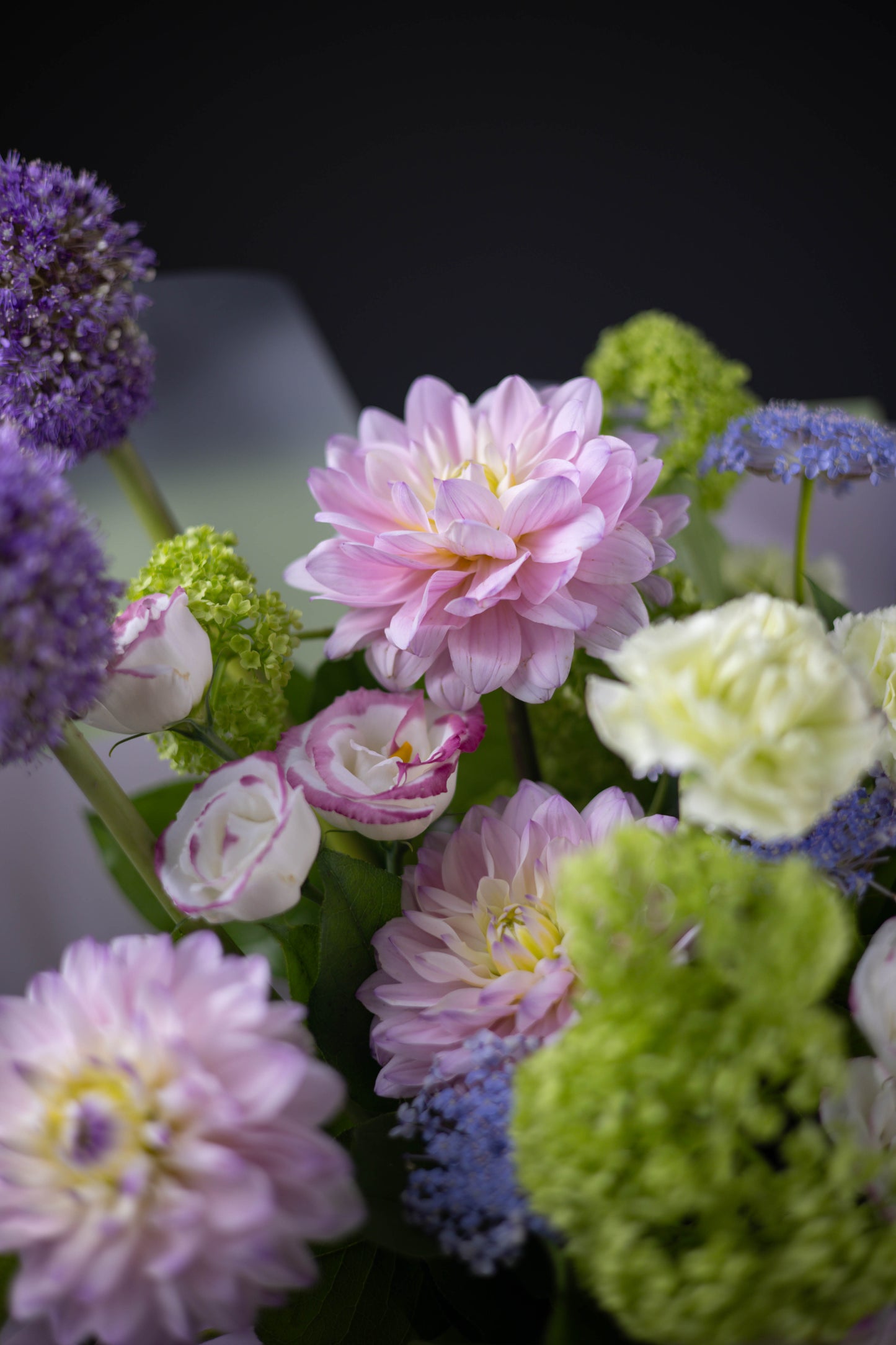 Side view of the pastel bouquet with pink anthuriums and purple alliums