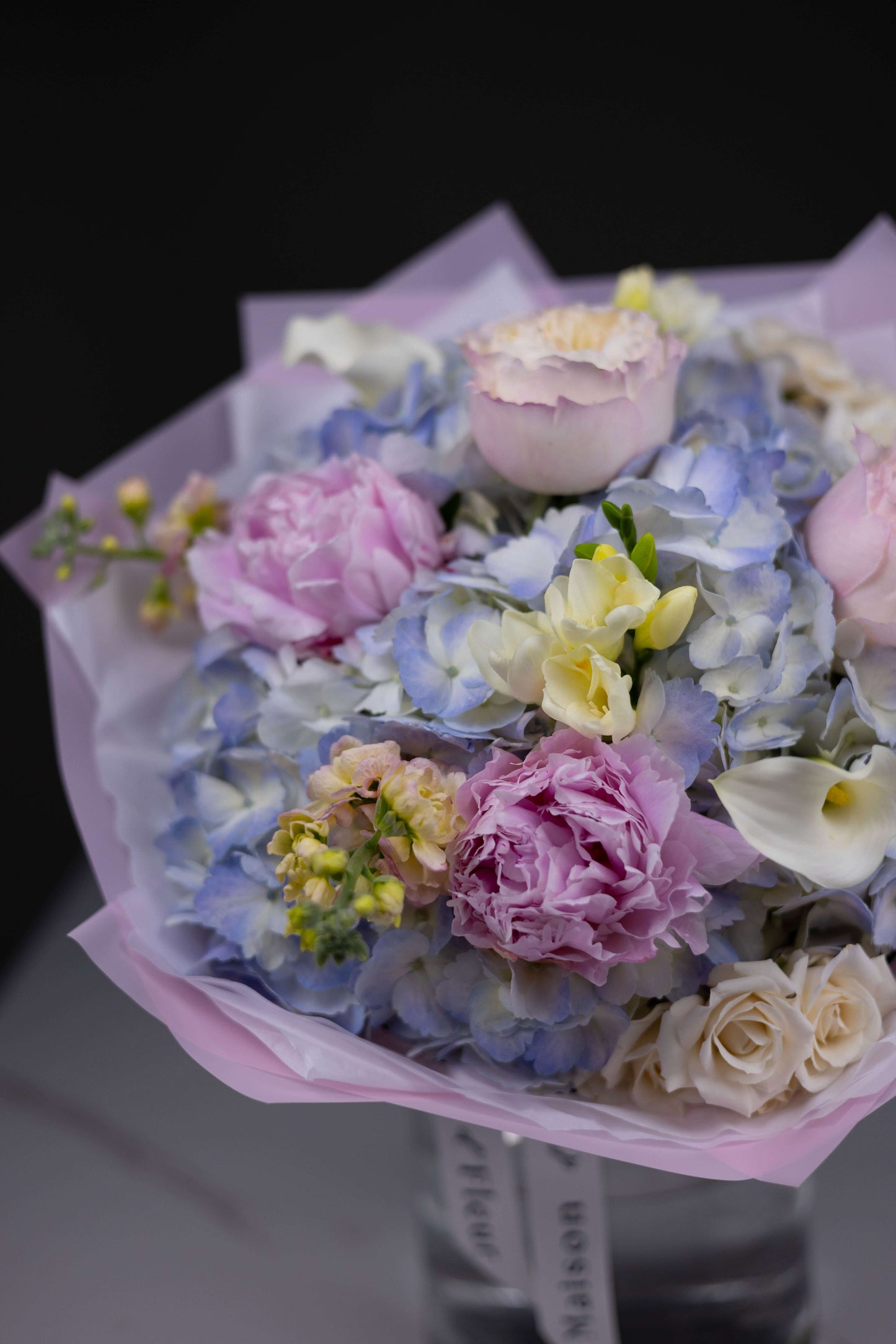 Pastel spring floral arrangement with cream calla lilies and pink roses in blush wrap – Maison d’Fleur boutique