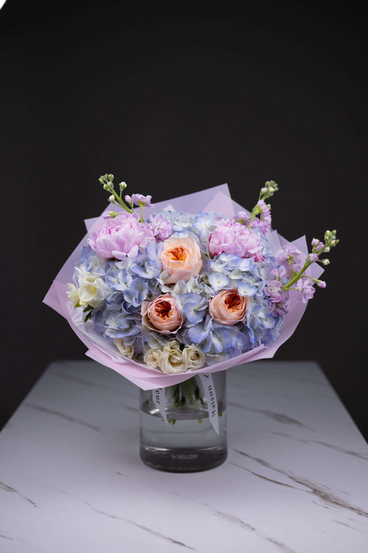 Luxury flower bouquet with Juliet garden roses, blue hydrangeas, and pink peonies by Maison d’Fleur Charlotte NC