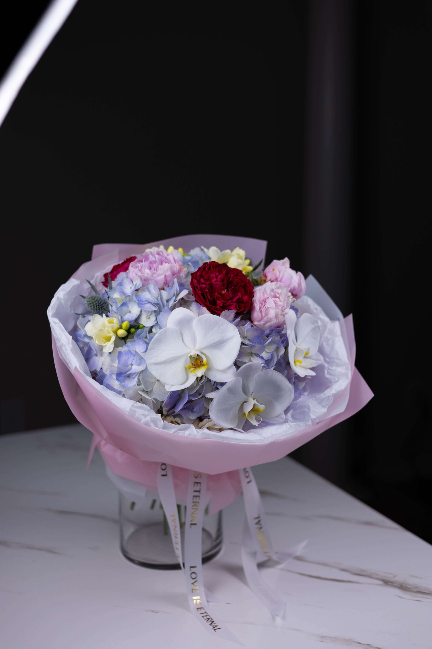 Elegant mixed flower arrangement with orchids, peonies, and hydrangeas for premium delivery in Charlotte NC