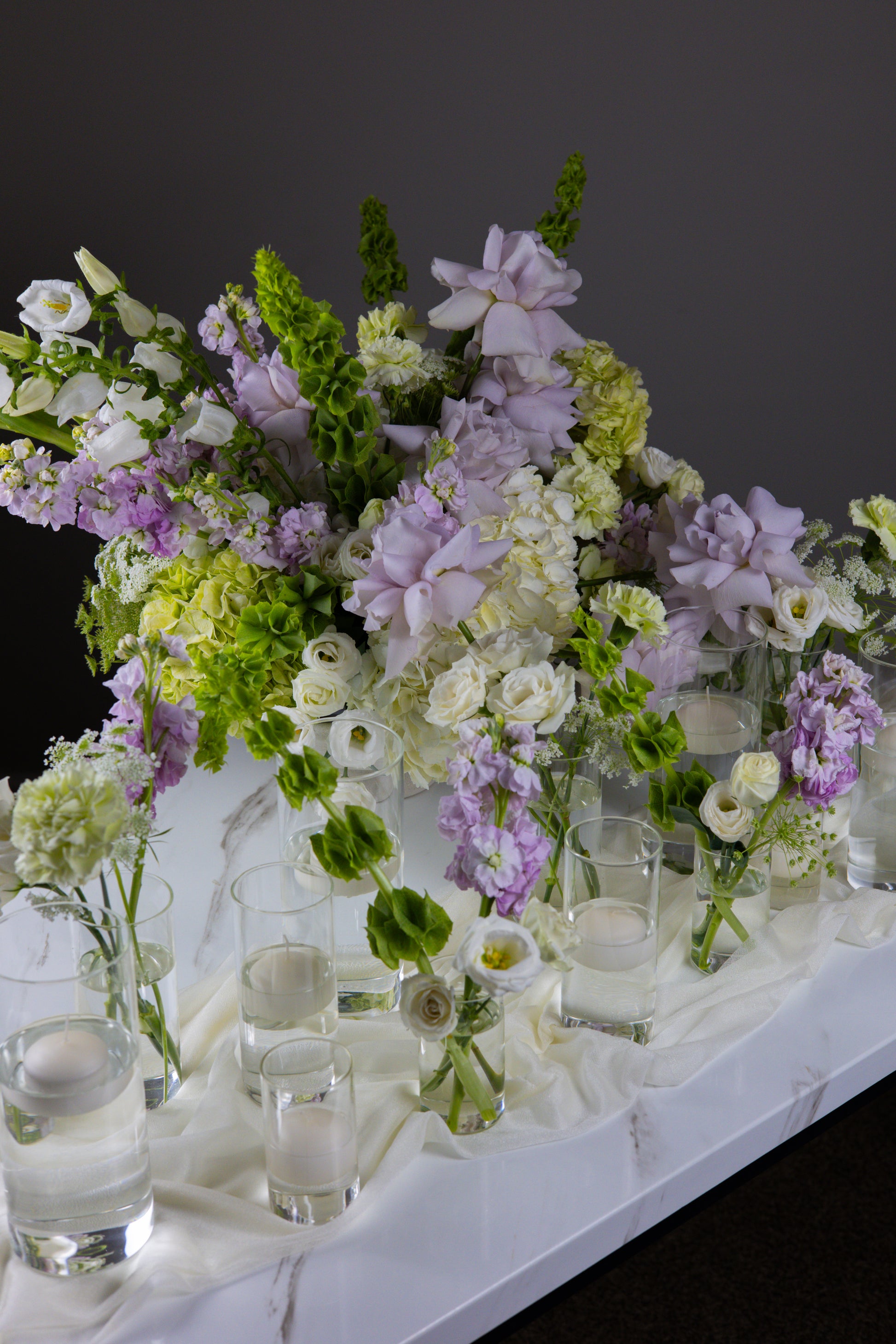 Decorative table setup with flowers and glasses on a dark background