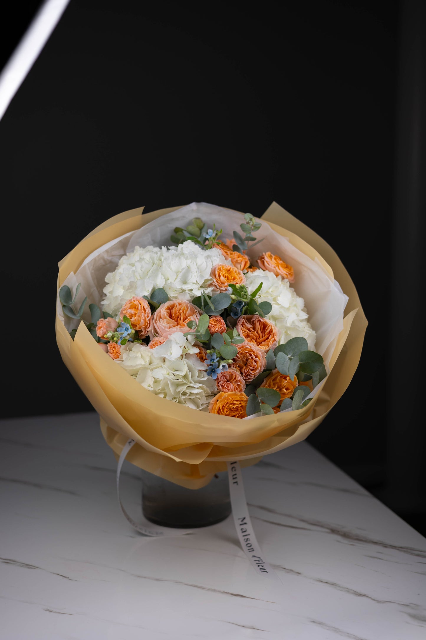 Luxury citrus-inspired floral arrangement in yellow wrap