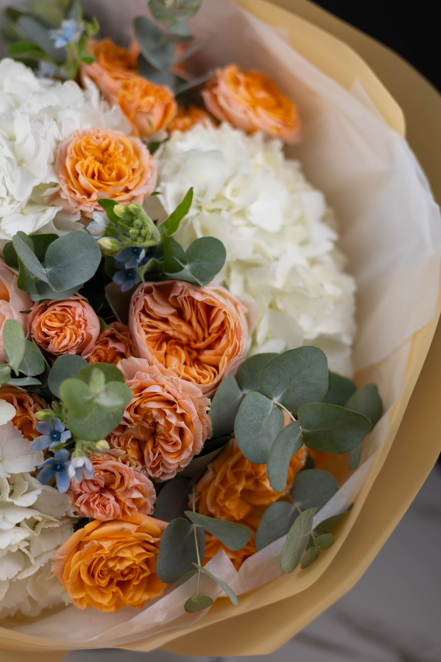 Luxury citrus-inspired floral arrangement in yellow wrap