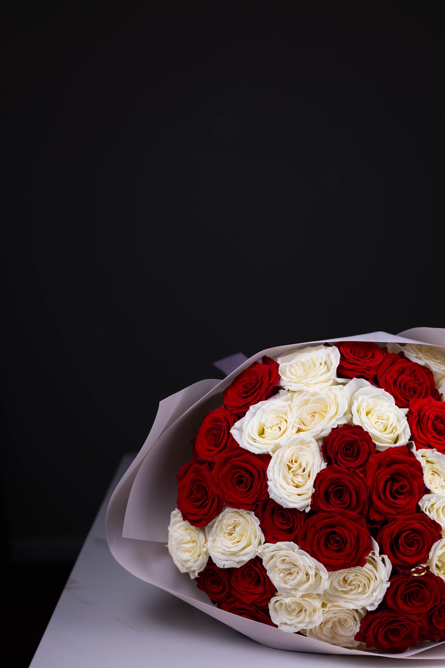 Side close-up of red and white roses in a checkerboard pattern