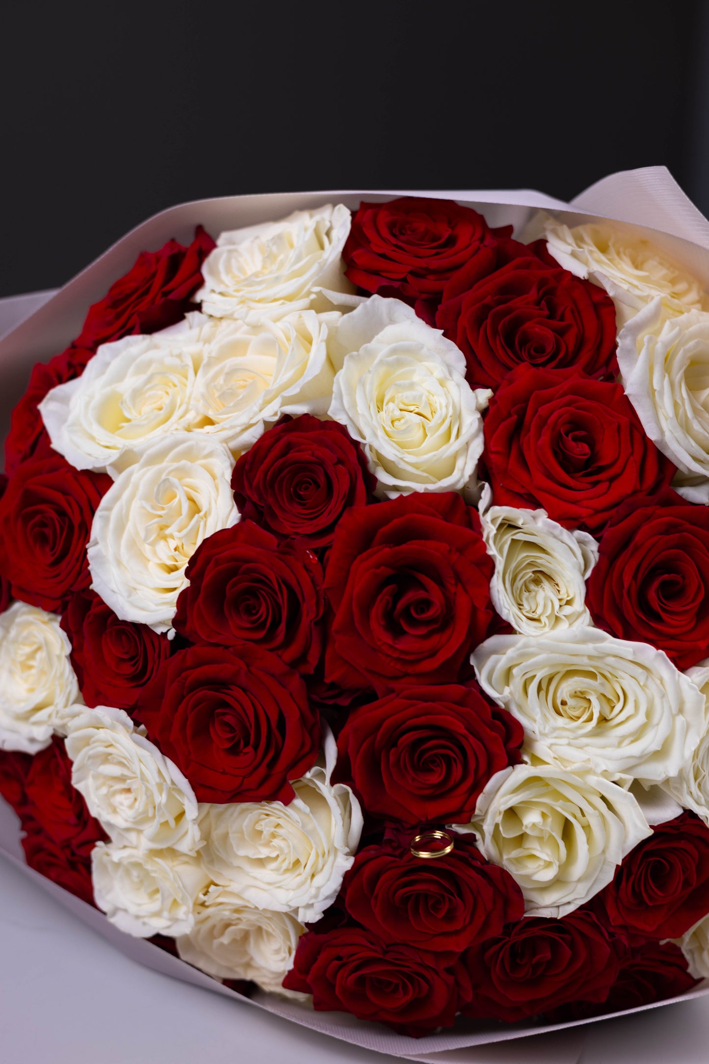 Bouquet of red and white roses on a dark background