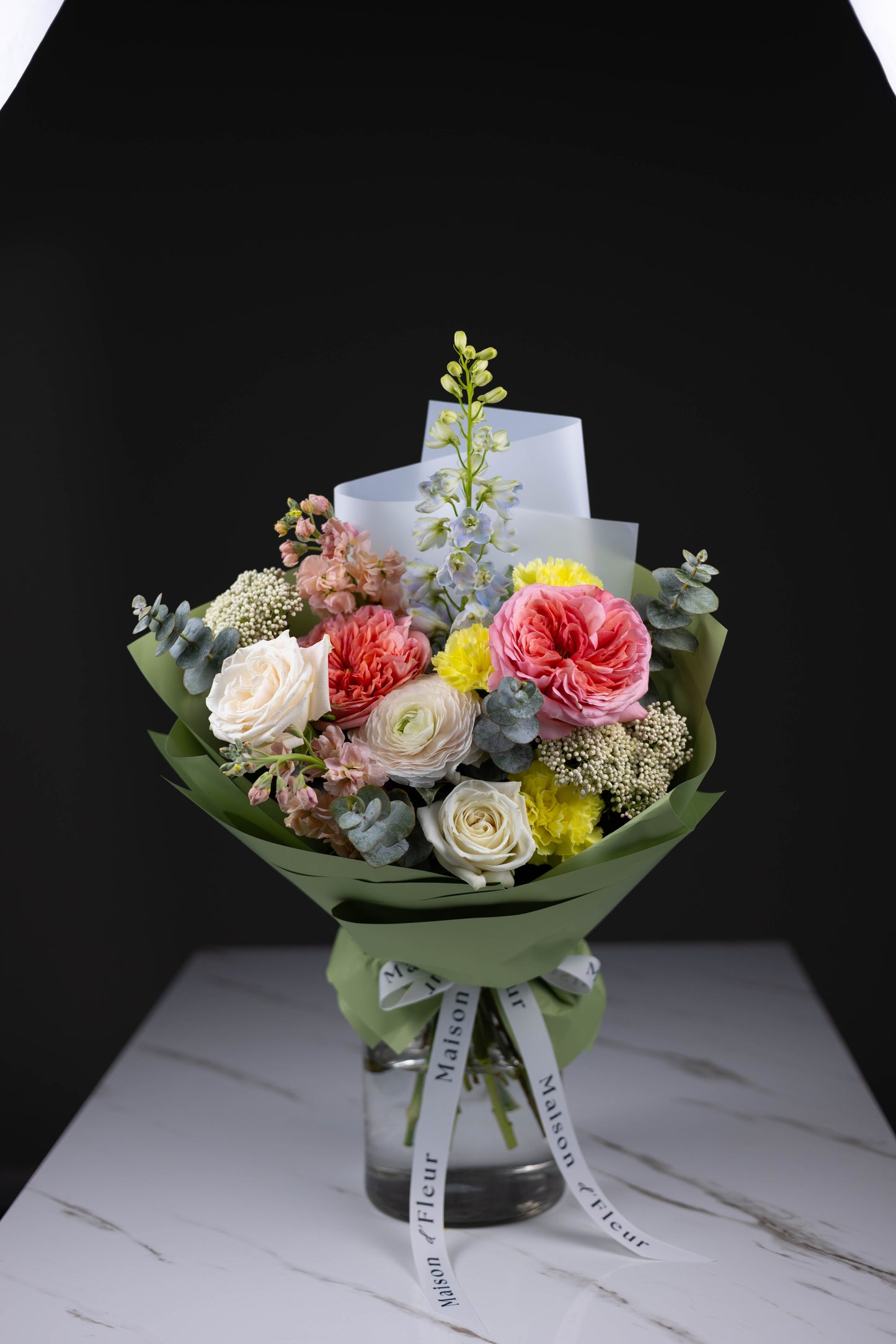 Maison d’Fleur luxury bouquet with roses, stock, and ranunculus in mint wrap