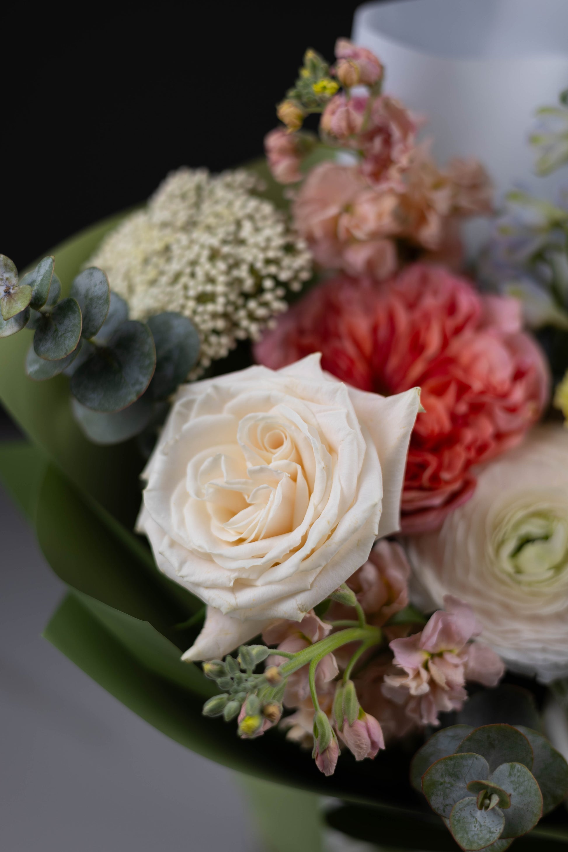 Elegant bouquet featuring blush ranunculus and blue delphinium by Maison d’Fleur