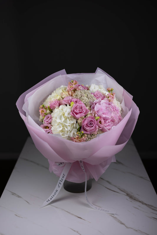 Soft pink and white rose bouquet in blush wrap – Charlotte NC florist