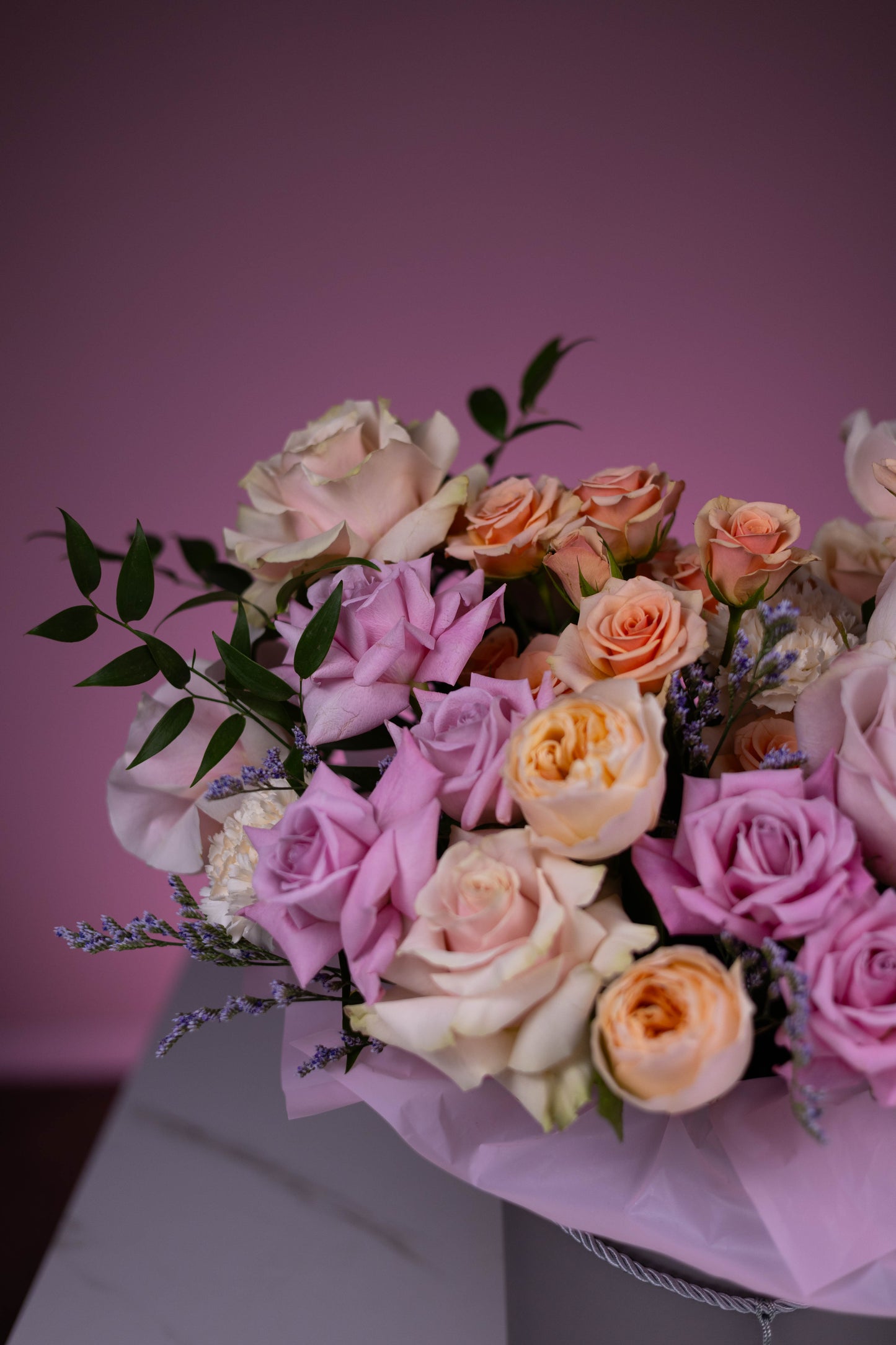 Bouquet of flowers with pink and white roses on a pink background