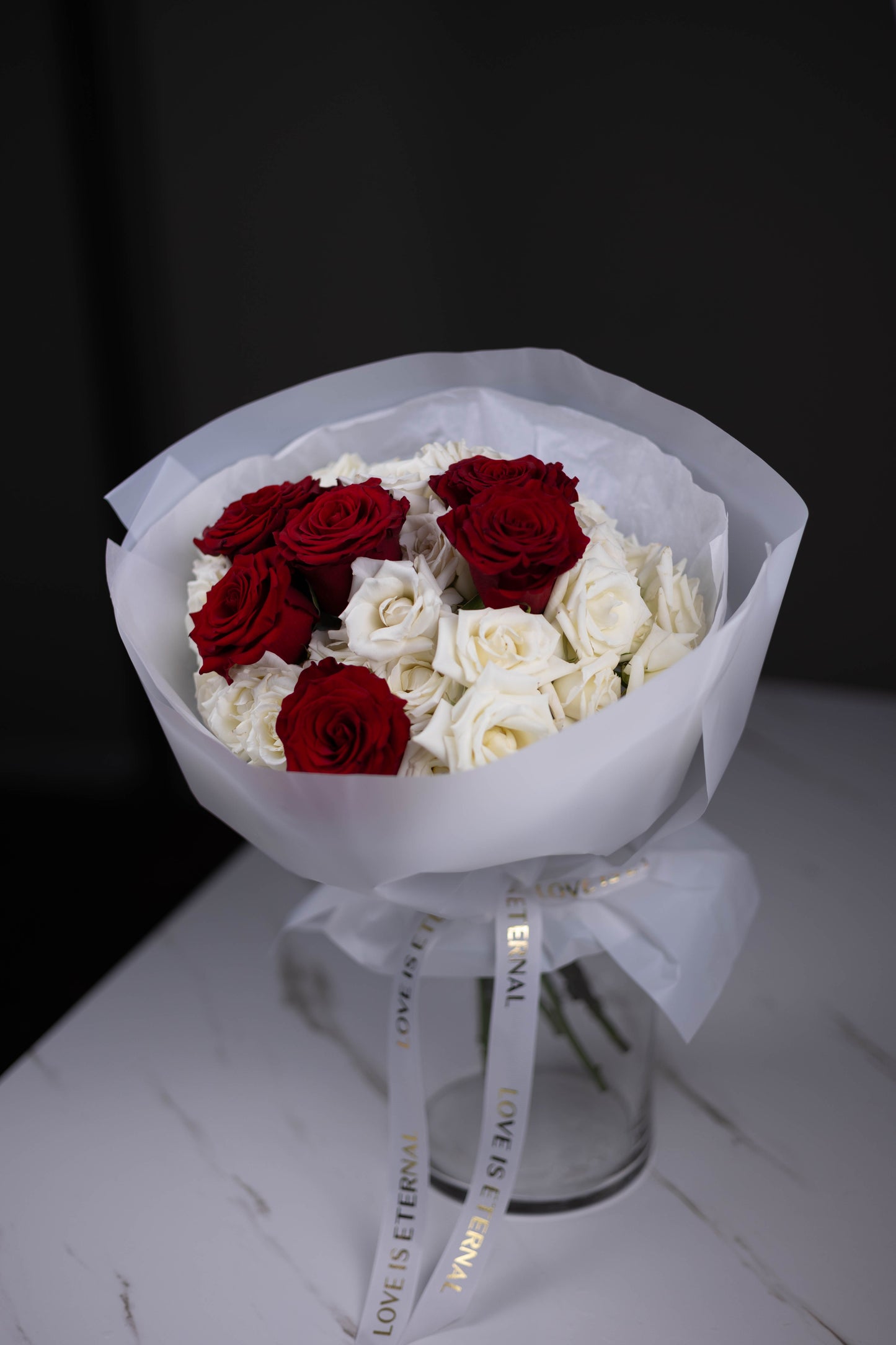 red roses with white roses hand-tied