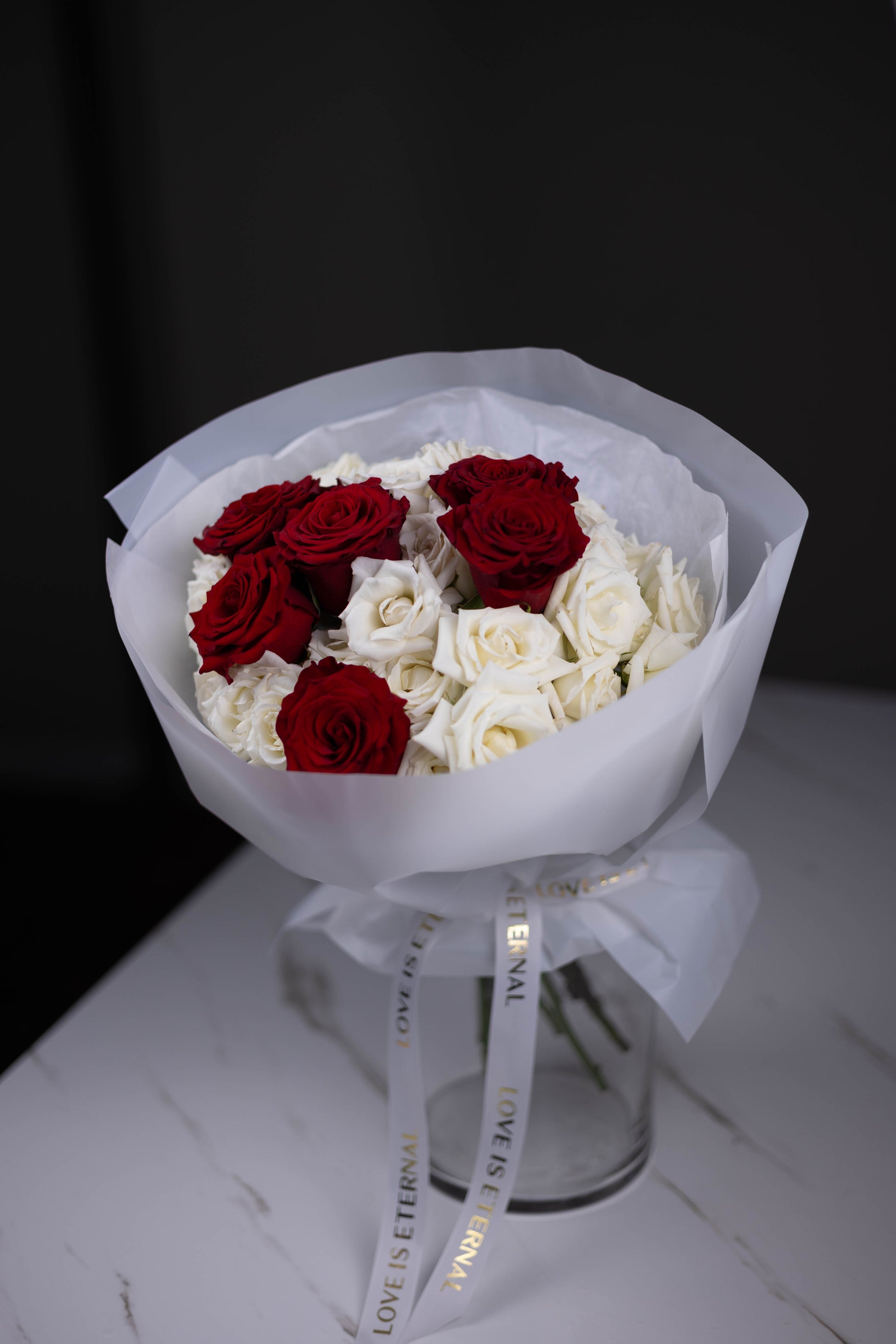 red roses with white roses hand-tied
