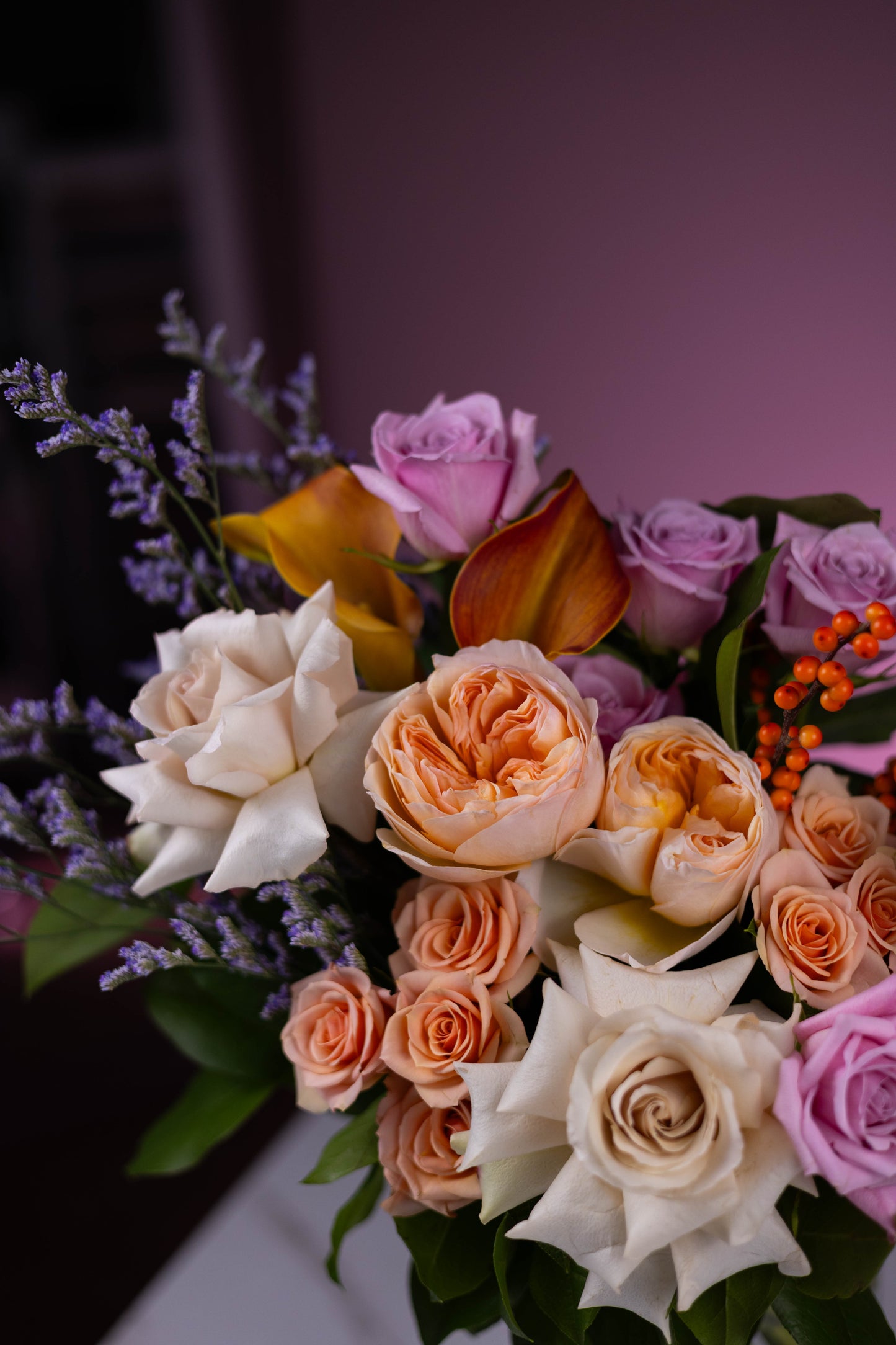 Bouquet of flowers with roses and tulips on a blurred background