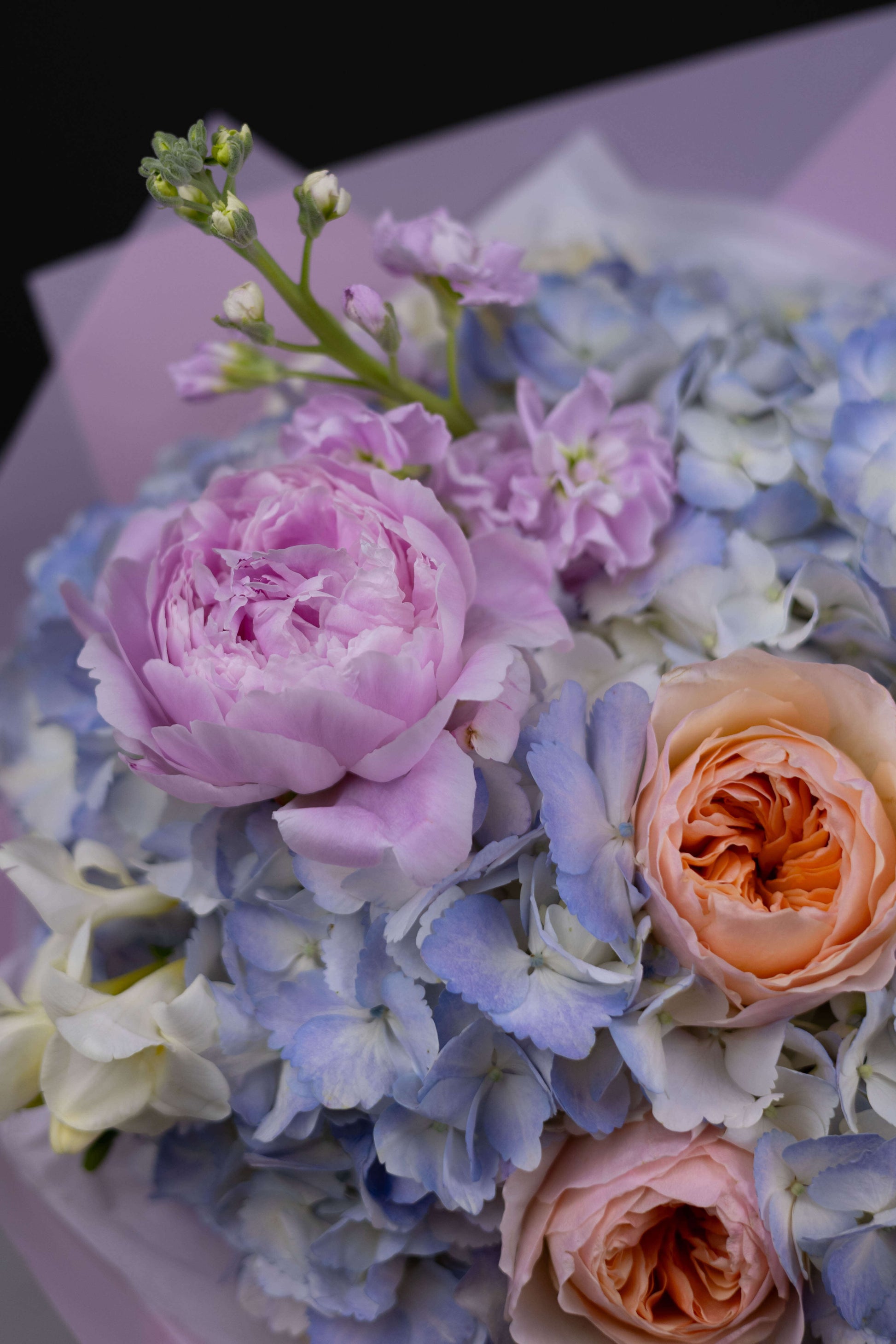 Close-up of luxury blue hydrangea and Juliet rose bouquet for spring gifting Charlotte NC