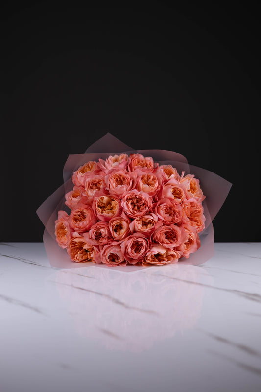 Large bouquet of luxury peach garden roses arranged in Maison d’Fleur’s signature blush wrapping