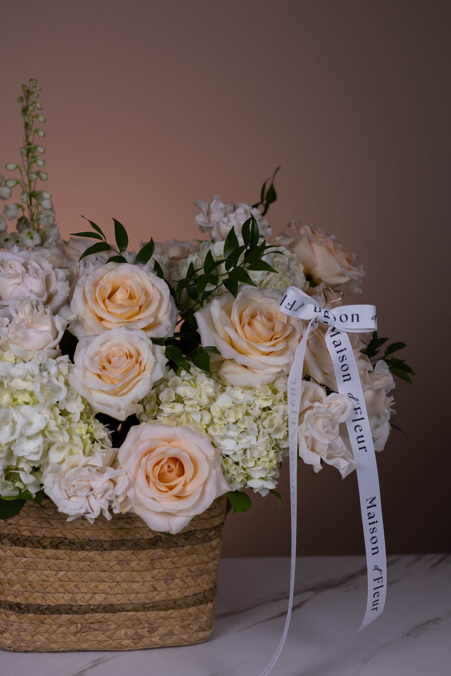 Floral arrangement with a ribbon on a neutral background