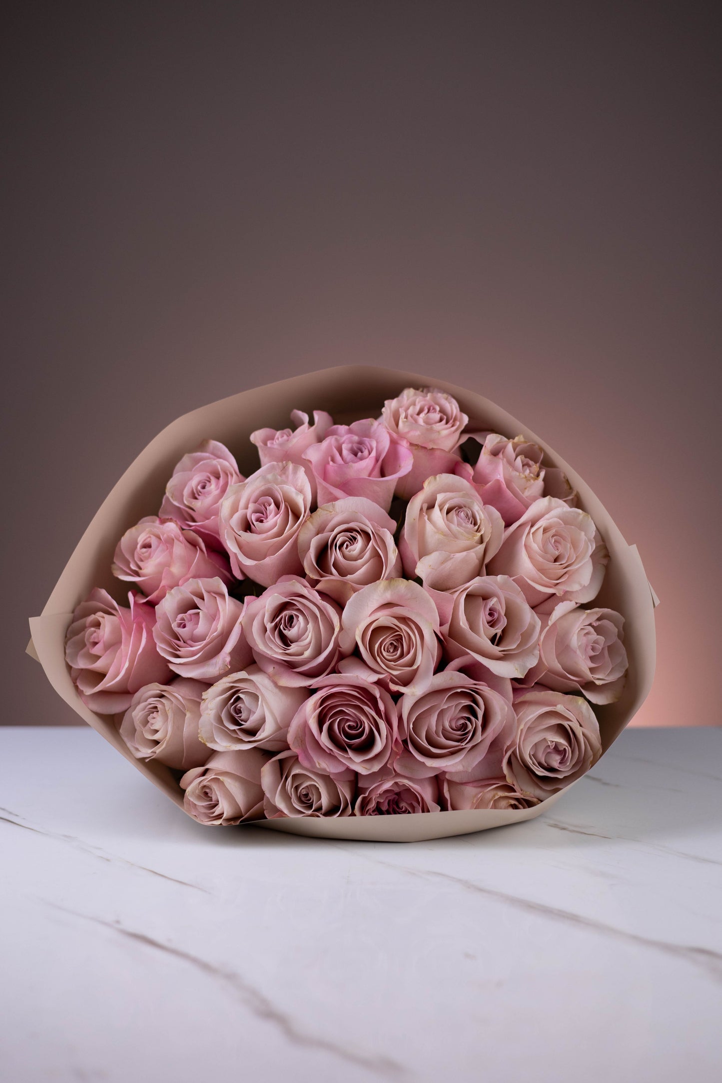 Luxury bouquet of 25 soft pink roses on marble surface – Maison d’Fleur floral styling
